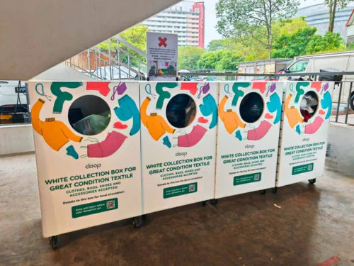 A row of clean, white Cloop donation bins located at a community space in Singapore.