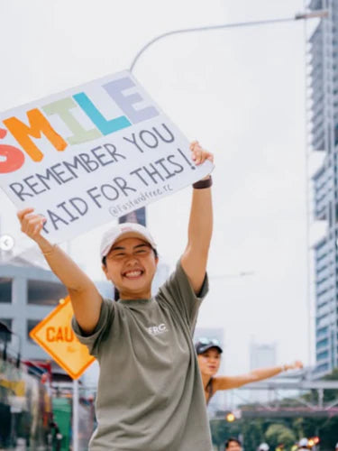A diverse group of Gen Z and millennial runners smiling after a run in Singapore with their run club.